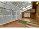 Sunroom with tile flooring and glass roof; featuring multiple windows with blinds for customizable natural light at 23 S Downey Ave, Indianapolis, IN 46219