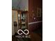 Interior view of a curio cabinet with glass shelves and a decorative display at 241 Deborah Ln, Whiteland, IN 46184