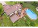 Aerial view showcases backyard pool, large deck, mature trees surrounding house, and fenced yard at 259 Glenbrook Ln, Avon, IN 46123