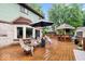 Expansive backyard deck featuring a covered dining area, outdoor seating, and a custom-built bar area at 259 Glenbrook Ln, Avon, IN 46123