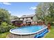 A spacious backyard features an above ground pool, a large deck, mature trees and a lawn at 259 Glenbrook Ln, Avon, IN 46123