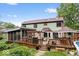 Expansive backyard featuring a large deck with seating, a covered patio, and a lush green lawn at 259 Glenbrook Ln, Avon, IN 46123