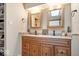Bathroom vanity with double sinks, wooden cabinets, granite countertops, and decorative mirrors providing a serene space at 259 Glenbrook Ln, Avon, IN 46123