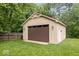 Well-maintained detached two car garage with a brown door and neutral siding nestled in a green lawn at 259 Glenbrook Ln, Avon, IN 46123