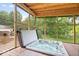 Relax in this screened in porch with a luxurious hot tub overlooking a serene backyard at 259 Glenbrook Ln, Avon, IN 46123
