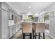 Modern kitchen featuring gray cabinets, stainless steel appliances, and bar seating with a view at 259 Glenbrook Ln, Avon, IN 46123