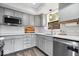 Stylish kitchen featuring stainless steel appliances, light countertops, and gray cabinetry at 259 Glenbrook Ln, Avon, IN 46123