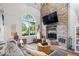 Bright living room with a brick fireplace, vaulted ceilings, and an open layout at 259 Glenbrook Ln, Avon, IN 46123