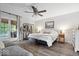 Spacious main bedroom featuring a ceiling fan, sitting area, and access to a sunroom, creating a relaxing retreat at 259 Glenbrook Ln, Avon, IN 46123