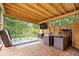 Relaxing sunroom featuring a hot tub, dining area, and screen windows with wooded views at 259 Glenbrook Ln, Avon, IN 46123