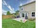 Backyard features a concrete patio, two grills, and ample green space at 2615 Pumpkin Patch Ln, Indianapolis, IN 46229