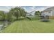 Spacious backyard featuring a lush lawn, black fence, mature tree, and trampoline at 2615 Pumpkin Patch Ln, Indianapolis, IN 46229