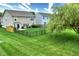 Well-maintained backyard with a healthy lawn, a black fence and mature tree, perfect for outdoor activities at 2615 Pumpkin Patch Ln, Indianapolis, IN 46229