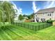 Lush green backyard is fenced and includes a view of the home at 2615 Pumpkin Patch Ln, Indianapolis, IN 46229
