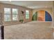 Spacious bonus room with plush carpet, bright windows, and unique wall art at 2615 Pumpkin Patch Ln, Indianapolis, IN 46229