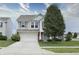 Charming two-story home featuring neutral siding, an attached garage, and a well-manicured front lawn at 2615 Pumpkin Patch Ln, Indianapolis, IN 46229