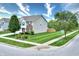 Two-story home featuring neutral siding, well-manicured front lawn, and an attached garage at 2615 Pumpkin Patch Ln, Indianapolis, IN 46229