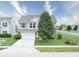 Attractive two-story home featuring a well-kept lawn, a driveway, and a mixture of siding and brick at 2615 Pumpkin Patch Ln, Indianapolis, IN 46229