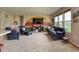 Inviting living room with carpet floors, large windows, comfortable seating, and entertainment center at 2615 Pumpkin Patch Ln, Indianapolis, IN 46229