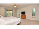 Comfortable main bedroom with ceiling fan, dresser, and view of the yard at 2615 Pumpkin Patch Ln, Indianapolis, IN 46229