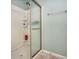 Clean shower with glass door and built in shelving at 2615 Pumpkin Patch Ln, Indianapolis, IN 46229