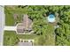 Aerial view showcases the home's backyard pool, lush landscaping, and well-maintained yard at 272 N Peterman Rd, Greenwood, IN 46142