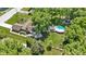 A bird's eye view of the home highlighting its pool, gazebo, expansive yard and tree coverage at 272 N Peterman Rd, Greenwood, IN 46142