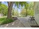 Landscaped backyard with mature trees, patio, and seating area is great for entertaining at 272 N Peterman Rd, Greenwood, IN 46142