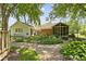 Beautiful backyard with garden beds, screened-in patio and well-maintained greenery and gravel at 272 N Peterman Rd, Greenwood, IN 46142
