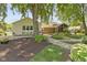 Spacious backyard featuring mature trees, lush landscaping, and a walkway to a screened-in porch at 272 N Peterman Rd, Greenwood, IN 46142