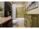 Cozy bathroom featuring a tub with shower, built in shelving, and olive green vanity at 272 N Peterman Rd, Greenwood, IN 46142