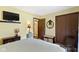 Comfortable bedroom featuring a TV, built-in storage, and an attached bathroom for added convenience at 272 N Peterman Rd, Greenwood, IN 46142