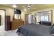 Bedroom with a dark bed frame, dresser with a mirror, closet doors, a ceiling fan, and recessed lighting at 272 N Peterman Rd, Greenwood, IN 46142