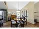 Well-lit dining room featuring a wooden table, stylish chairs, and views into the kitchen at 272 N Peterman Rd, Greenwood, IN 46142