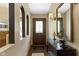 Inviting foyer with stylish mirror, console table, and hardwood floors at 272 N Peterman Rd, Greenwood, IN 46142