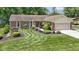 Well-maintained brick home with a lush lawn, lovely landscaping, and convenient driveway at 272 N Peterman Rd, Greenwood, IN 46142