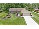 Charming brick home featuring a well-kept lawn, mature landscaping, and an attached two-car garage at 272 N Peterman Rd, Greenwood, IN 46142