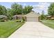 Charming single-story home with attached two-car garage and beautiful landscaping at 272 N Peterman Rd, Greenwood, IN 46142
