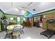 Spacious game room featuring a bar area, seating, and a fun, retro aesthetic at 272 N Peterman Rd, Greenwood, IN 46142