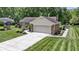 Lovely exterior view of home with attractive landscaping, a long driveway, and a two-car garage at 272 N Peterman Rd, Greenwood, IN 46142