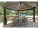 Gazebo featuring outdoor dining set, overhead fan and a view of the backyard swimming pool at 272 N Peterman Rd, Greenwood, IN 46142