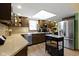 Well-lit kitchen with stainless appliances, a central island, a skylight, and warm wood cabinetry at 272 N Peterman Rd, Greenwood, IN 46142