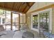 Screened-in porch with furniture, stone table, wood ceiling, and brick exterior at 272 N Peterman Rd, Greenwood, IN 46142