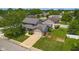 Aerial view of a home with a well-manicured lawn, mature trees, an attached garage, and a long driveway at 2872 N Prairie Stream Way, Columbus, IN 47203
