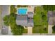 Aerial view of a home with a swimming pool, green grass, trees, and a driveway at 2872 N Prairie Stream Way, Columbus, IN 47203