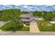 Aerial view of a charming two-story home with manicured lawn, mature trees and an attached garage at 2872 N Prairie Stream Way, Columbus, IN 47203