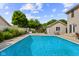 Beautiful backyard with a sparkling pool, a wide patio, and lush greenery providing a serene and private outdoor retreat at 2872 N Prairie Stream Way, Columbus, IN 47203