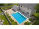 Aerial view of backyard featuring in-ground pool, a patio area, lush landscaping, and fencing at 2872 N Prairie Stream Way, Columbus, IN 47203
