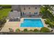 Backyard aerial view showcasing an in-ground pool, patio, adjacent pool house and manicured garden at 2872 N Prairie Stream Way, Columbus, IN 47203