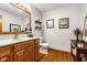 Well-lit bathroom with vanity, nautical decor, and hardwood floors at 2872 N Prairie Stream Way, Columbus, IN 47203
